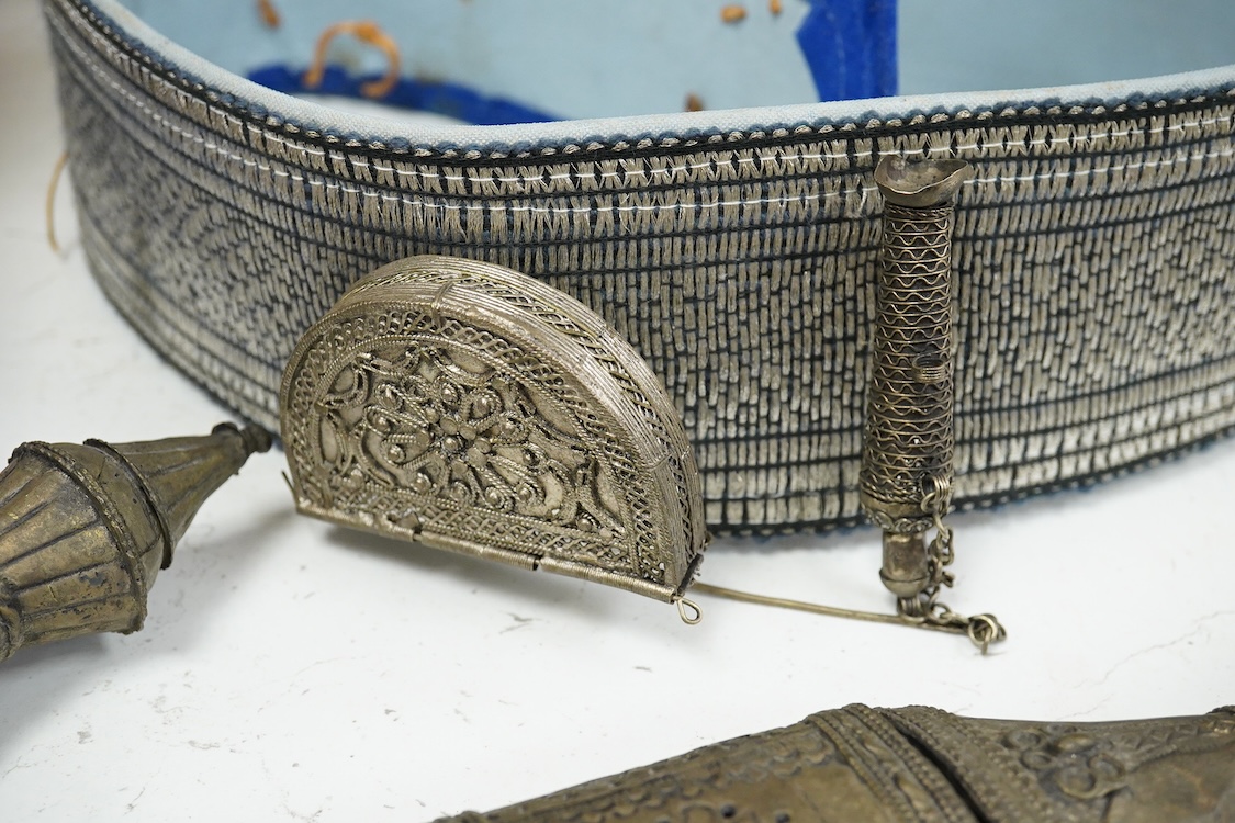 Two Yemeni white metal daggers white and two belts, largest dagger 31cm long